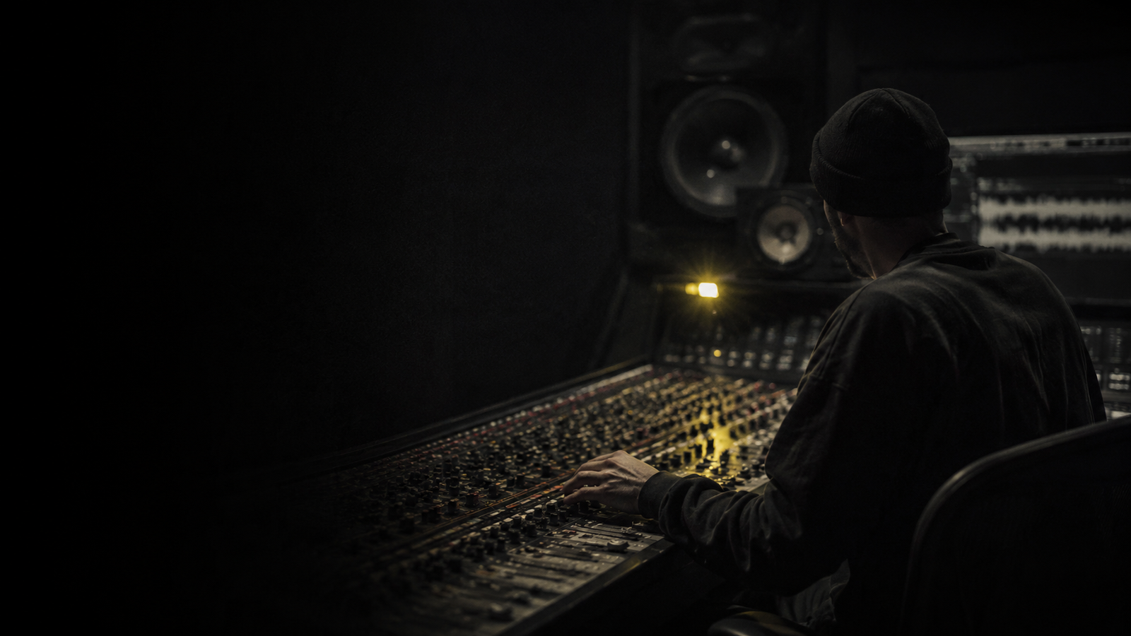Producer working at a studio mixing desk